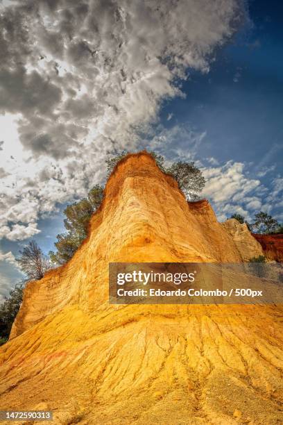 low angle view of rock formation against sky,roussillon,france - vaucluse stock pictures, royalty-free photos & images