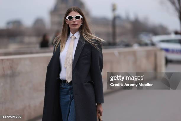 Veronika Heilbrunner is seen wearing a grey coat, white blouse, blue jeans, brown Timberland boots and white sunglasses and a mini Louis Vuitton...