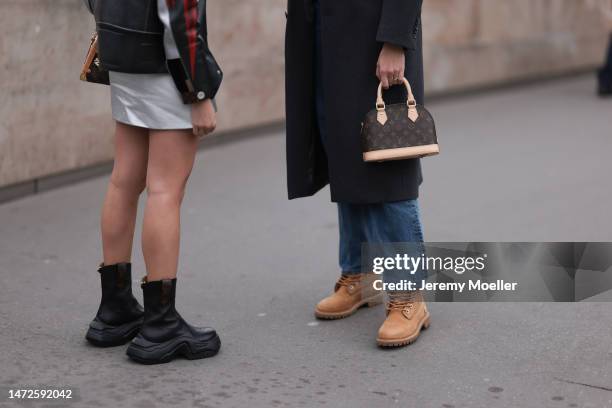 Veronika Heilbrunner is seen wearing a grey coat, white blouse, blue jeans pants, brown Timberland boots and white sunglasses and a mini Louis...