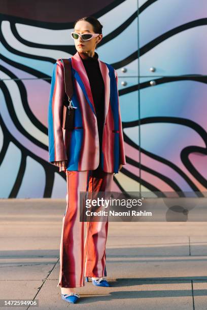 An attendee wears a Hosbjerg striped suit at Melbourne Fashion Festival on March 10, 2023 in Melbourne, Australia.