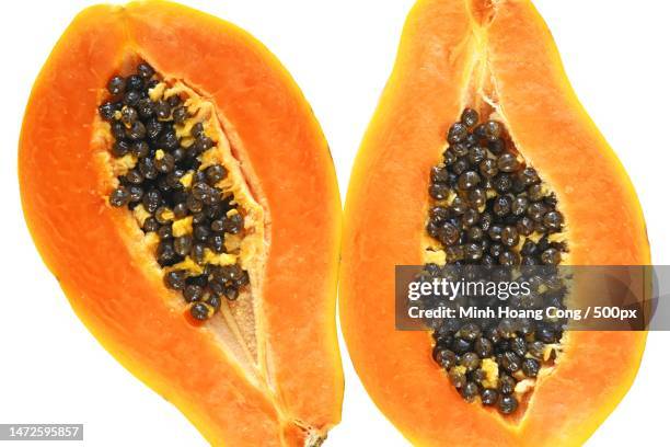 close-up of papaya against white background,france - papaya stock-fotos und bilder