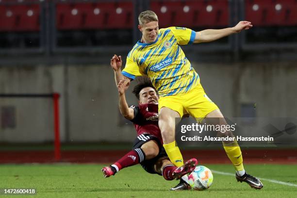 Jens Castrop of Nuernberg battles for the ball with Lion Lauberbach of Braunschweig during the Second Bundesliga match between 1. FC Nürnberg and...