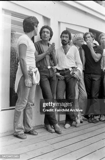 Artist David Hockney watches the show with friends.