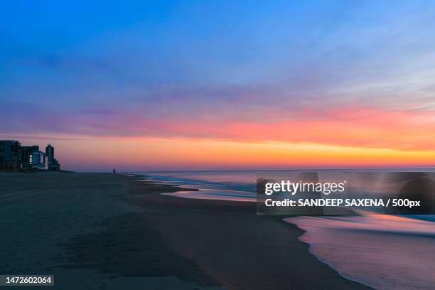 scenic view of beach against sky during sunset,ocean city,maryland,united states,usa - ocean city maryland stock pictures, royalty-free photos & images