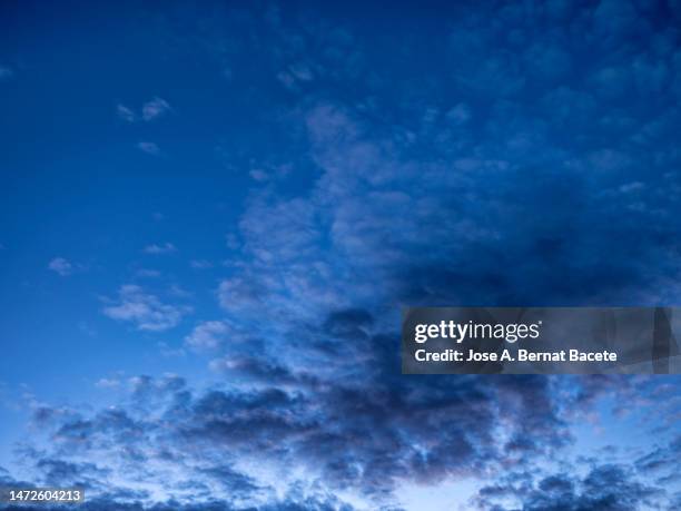 full frame, evening sky with some high clouds during the blue hour. - blue hour imagens e fotografias de stock