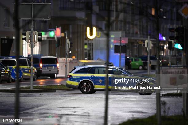Police secure the nearby area of a pharmacy where a perpetrator is reportedly holding a hostage on March 10, 2023 in Karlsruhe, Germany. Police have...