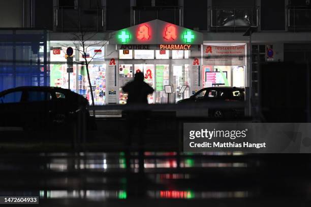 Police surround a pharmacy where a perpetrator is reportedly holding a hostage on March 10, 2023 in Karlsruhe, Germany. Police have cordoned off the...