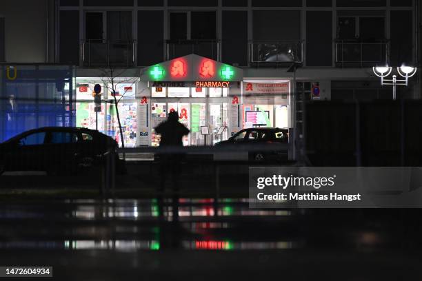 Police surround a pharmacy where a perpetrator is reportedly holding a hostage on March 10, 2023 in Karlsruhe, Germany. Police have cordoned off the...