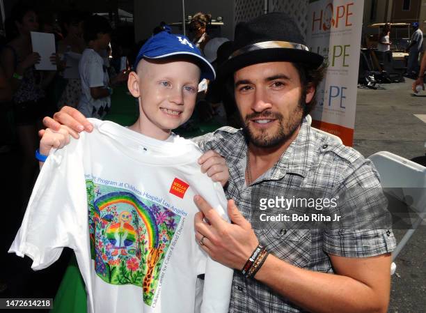 American Idol singer Luke Menard poses with young cancer patient Joseph Moore, 7 of San Dimas at Paramount Studios during 'Celebrate Life with Hope'...