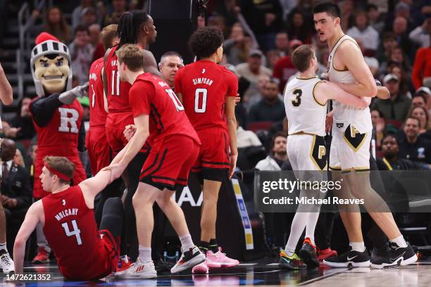 Zach Edey of the Purdue Boilermakers is separated by Braden Smith after elbowing Paul Mulcahy of the Rutgers Scarlet Knights in a scuffle during the...