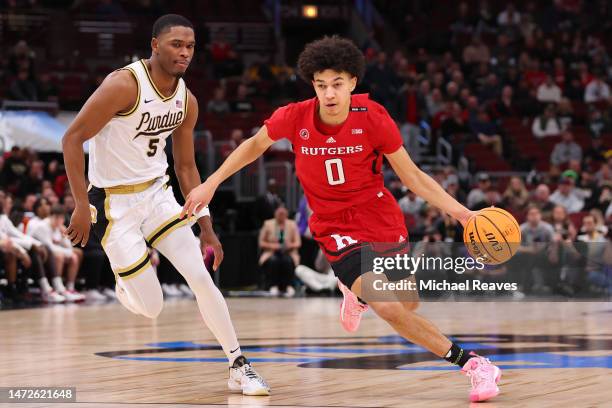 Derek Simpson of the Rutgers Scarlet Knights dribbles against Brandon Newman of the Purdue Boilermakers during the first half in the quarterfinals of...