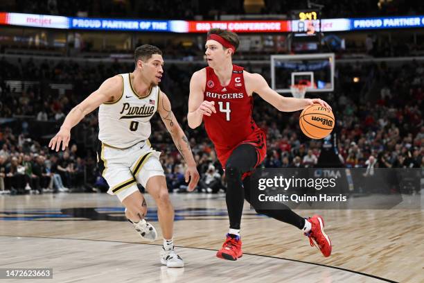 Paul Mulcahy of the Rutgers Scarlet Knights drives with the basketball against Mason Gillis of the Purdue Boilermakers during the second half in the...