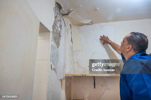 bricklayer analyzes apartment leak - leaking ceiling stock pictures, royalty-free photos & images