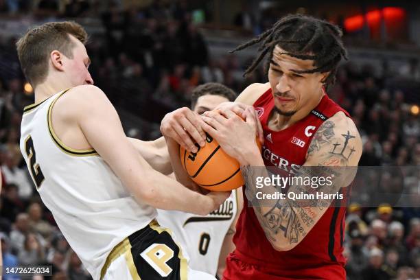 Caleb McConnell of the Rutgers Scarlet Knights and Fletcher Loyer of the Purdue Boilermakers battle for the basketball during the second half in the...