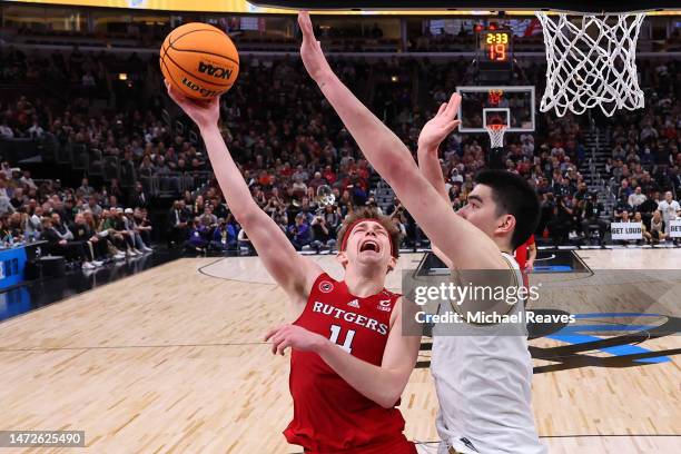 Zach Edey of the Purdue Boilermakers defends a shot by Paul Mulcahy of the Rutgers Scarlet Knights during the second half in the quarterfinals of the...