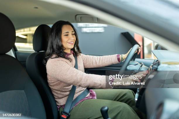 mature woman customer checking a car to buy at showroom - air conditioner car stock pictures, royalty-free photos & images