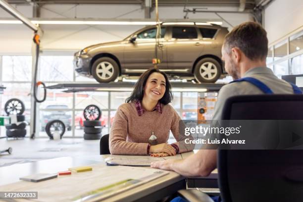 happy and satisfied female customer meeting with service station manager - bilverkstad bildbanksfoton och bilder