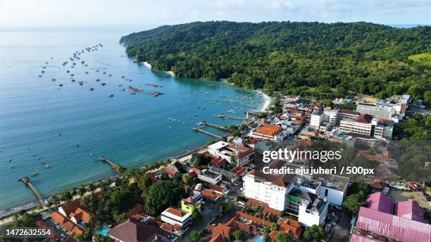 high angle view of townscape by sea against sky,pananjung,indonesia - eju stockfoto's en -beelden