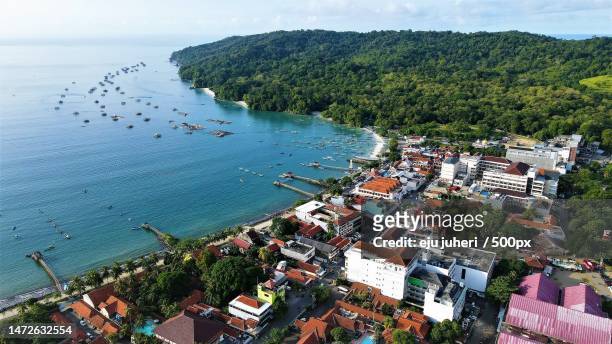 high angle view of townscape by sea against sky,pananjung,indonesia - eju stock pictures, royalty-free photos & images
