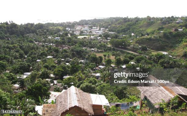 high angle view of houses and trees against sky,honiara,solomon islands - honiara stock-fotos und bilder