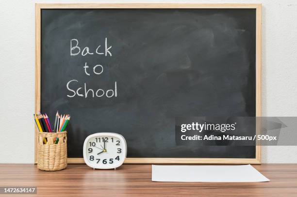 back to school and education concept to learn to improve skills - desk of student alarm clock books and pencils stock pictures, royalty-free photos & images