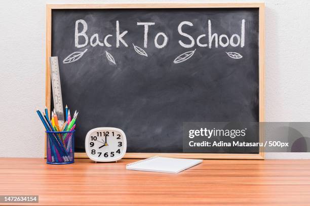 back to school and education concept to learn to improve skills - desk of student alarm clock books and pencils stock pictures, royalty-free photos & images