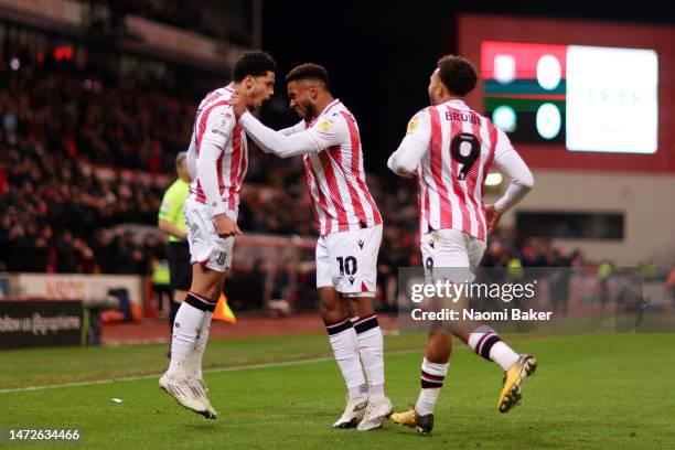 Ki-Jana Hoever of Stoke City celebrates with teammates Tyrese Campbell and Jacob Brown of Stoke City after scoring the team's first goal during the...