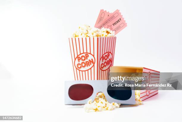 bucket of popcorn with cinema tickets and 3d glasses on white background. - movie explosion stockfoto's en -beelden