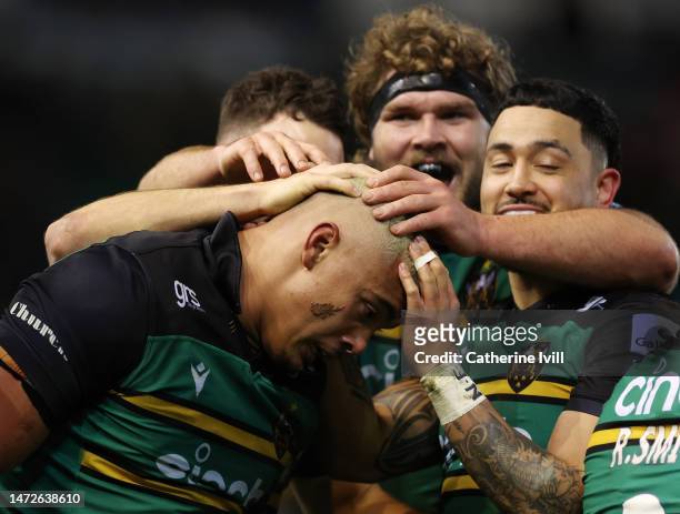 Juarno Augustus of Northampton Saints is congratulated after he scores the teams second try during the Gallagher Premiership Rugby match between...