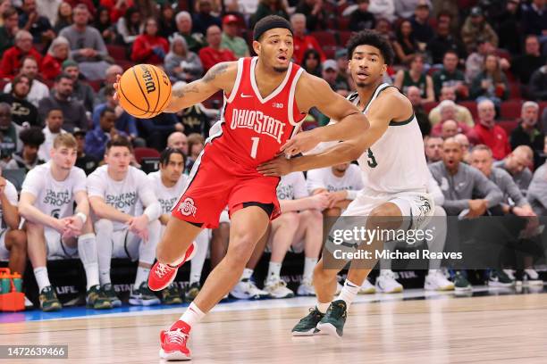 Roddy Gayle Jr. #1 of the Ohio State Buckeyes drives to the basket against Jaden Akins of the Michigan State Spartans during the first half in the...