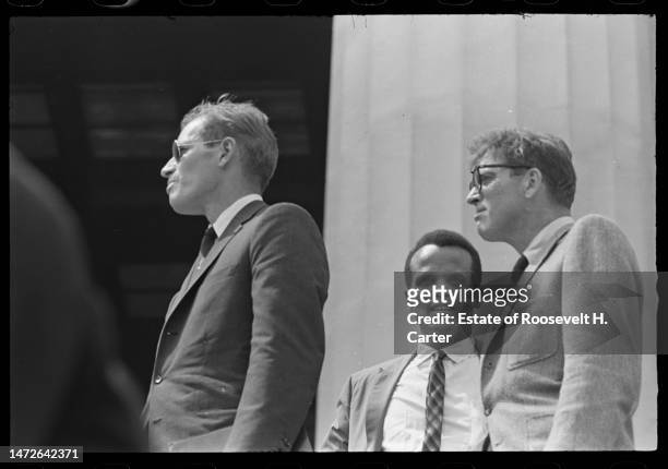 View of, from left, American actors Charlton Heston , Harry Belafonte, and Burt Lancaster as they stand outside the Lincoln Memorial during the March...