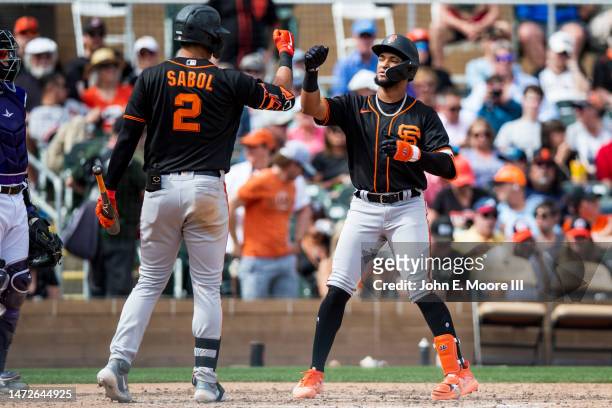 Luis Matos of the San Francisco Giants bumps fists with Blake Sabol after hitting a home run during the fifth inning of the Spring Training game...