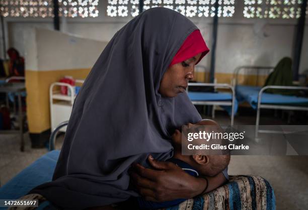 Nuurto, aged 28, cradles her one-year-old child suffering from severe acute malnutrition at the Trocaire Doolow Hospital on October 15,2022 in...