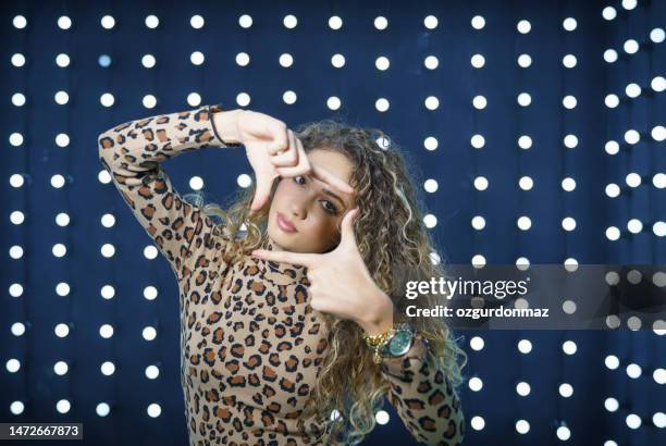 attractive young woman posing over neon lights, studio shot - neon fluorescent hair stock pictures, royalty-free photos & images