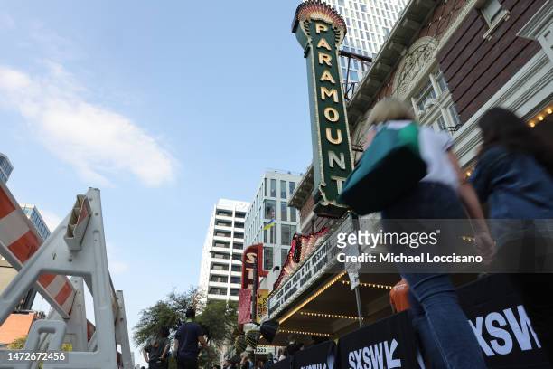 Pedestrians walk by the marquee during the "Dungeons & Dragons: Honor Among Thieves" world premiere during the 2023 SXSW Conference and Festivals at...