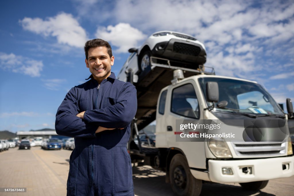 Happy truck driver with a shipment of cars