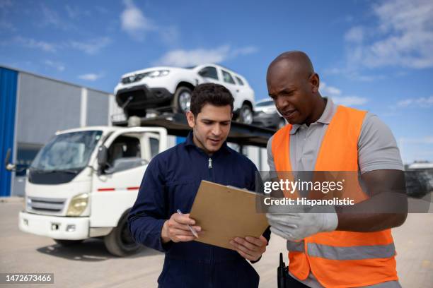 supervisor talking to truck driver transporting cars from a warehouse - fleet manager stock pictures, royalty-free photos & images