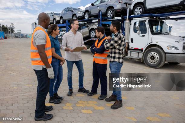boss talking to a group of workers transporting cars - fleet manager stock pictures, royalty-free photos & images