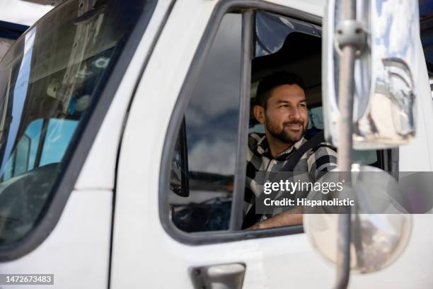 happy truck driver driving his cargo vehicle - lorry driver stock pictures, royalty-free photos & images
