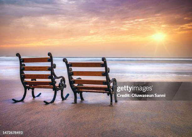 lonely chairs sea sunset - banjul nature stock-fotos und bilder