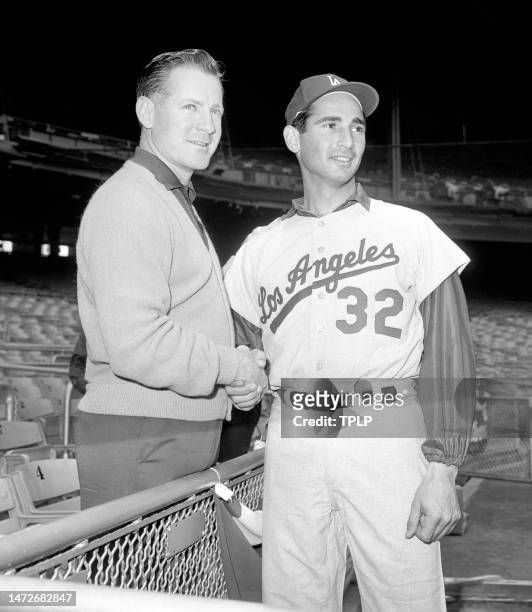 Pitcher Whitey Ford of the New York Yankees and pitcher Sandy Koufax of the Los Angeles Dodgers pose for a portrait during practice prior to Game 1...