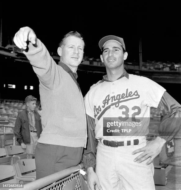 Pitcher Whitey Ford of the New York Yankees and pitcher Sandy Koufax of the Los Angeles Dodgers look over the stadium during practice prior to Game 1...