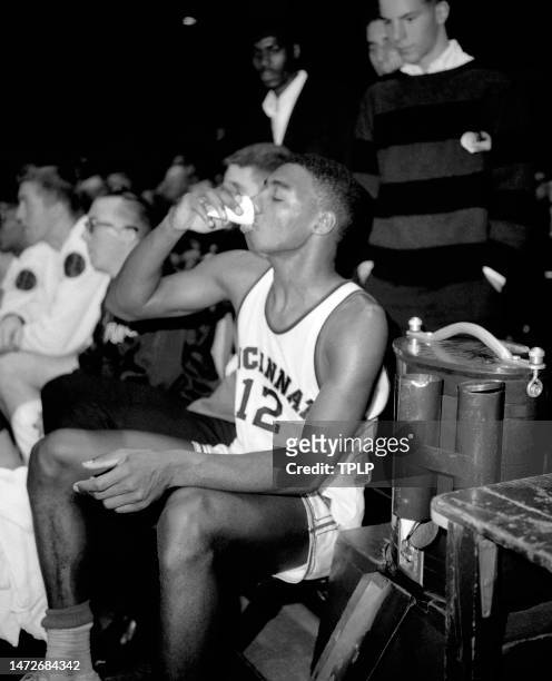 Oscar Robertson of the Cincinnati Bearcats drinks on the bench during the ECAC Holiday Festival basketball tournament at Madison Square Garden in New...