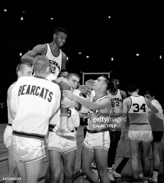 Oscar Robertson of the Cincinnati Bearcats is carried on the shoulders of joyful teammates after landing his team to the championship of the ECAC...