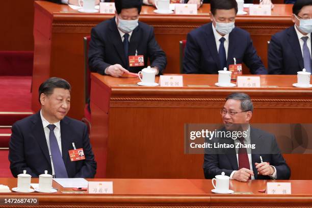 Chinese President Xi Jinping speaks with Politburo Standing Committee member Li Qiang during the opening of the fourth plenary session of the...