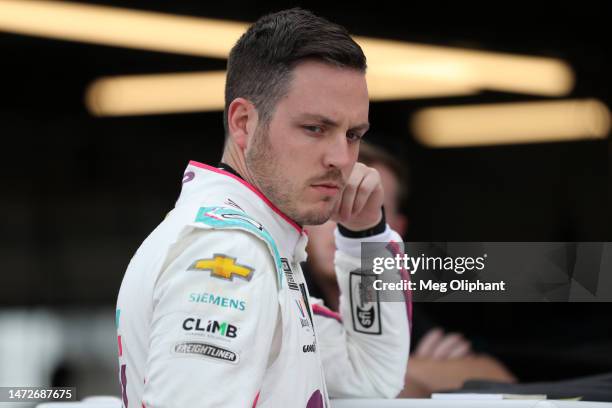 Alex Bowman, driver of the Ally Best Friends Chevrolet, waits in the garage area to during practice for the NASCAR Cup Series United Rentals Work...