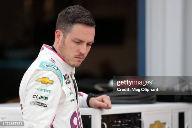 Alex Bowman, driver of the Ally Best Friends Chevrolet, waits in the garage area to during practice for the NASCAR Cup Series United Rentals Work...