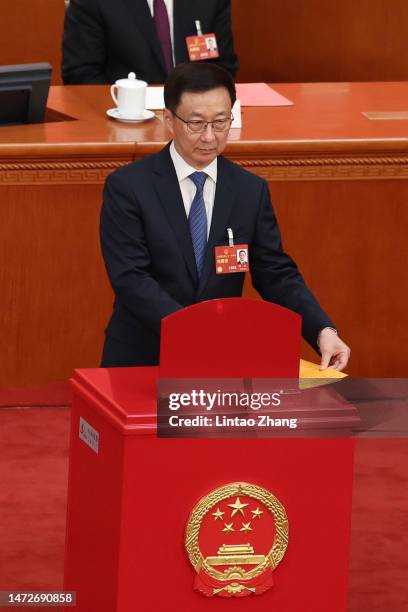 Politburo Standing Committee member Han Zheng votes during the opening of the fourth plenary session of the National People's Congress on March 11,...