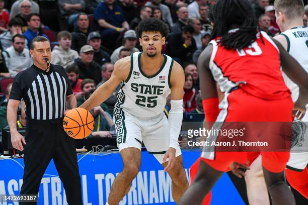 Malik Hall of the Michigan State Spartans dribbles the ball against Isaac Likekele of the Ohio State Buckeyes during the first half of a Big Ten...