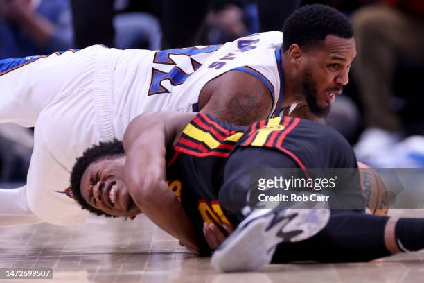 Monte Morris of the Washington Wizards and De'Andre Hunter of the Atlanta Hawks go after a loose ball in the second half at Capital One Arena on...